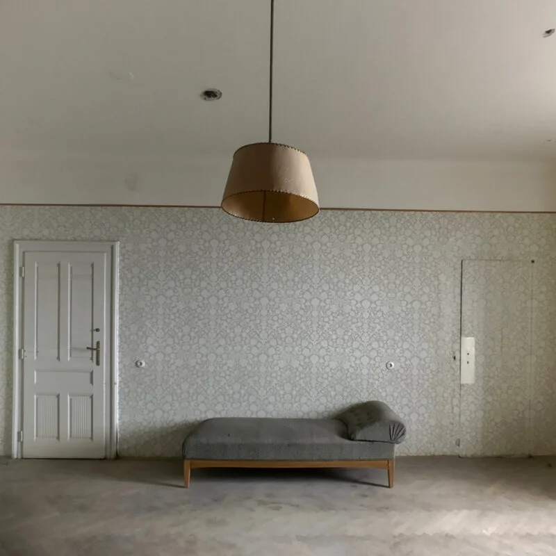 Couch in an abandoned hotel room at the Suedbahn Hotel Semmering