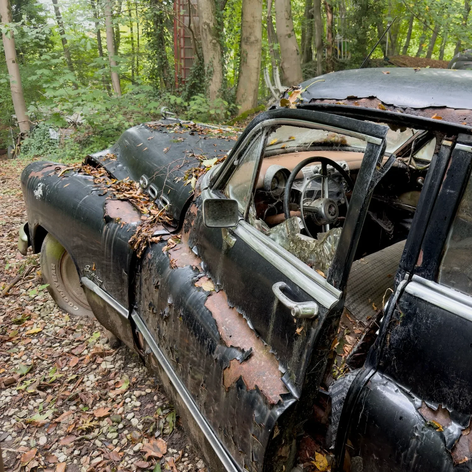 Open door and smashed window of a Buick Super