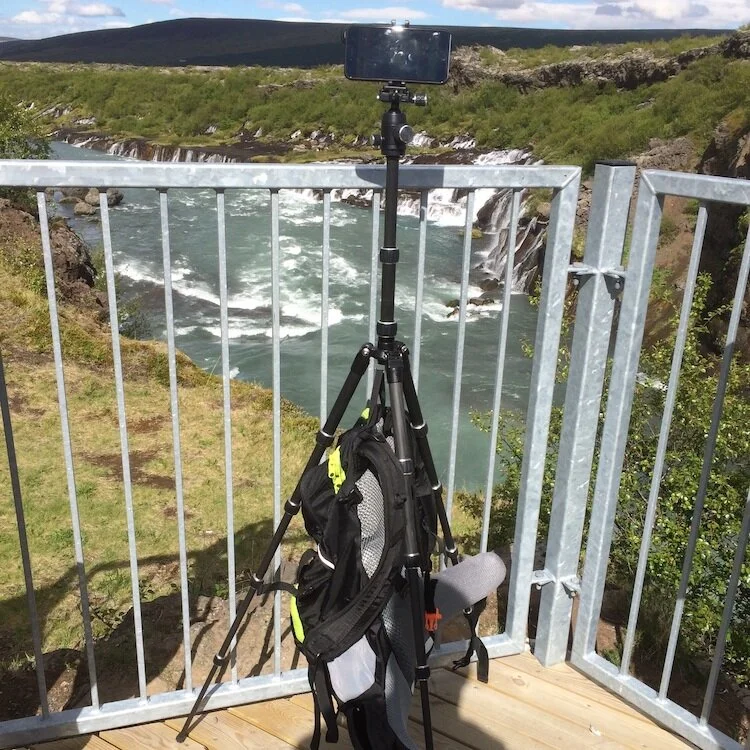 AmazonBasics Travel Tripod with iPhone mounted using Joby Griptight with my old backpack used as a stabilizing weight.